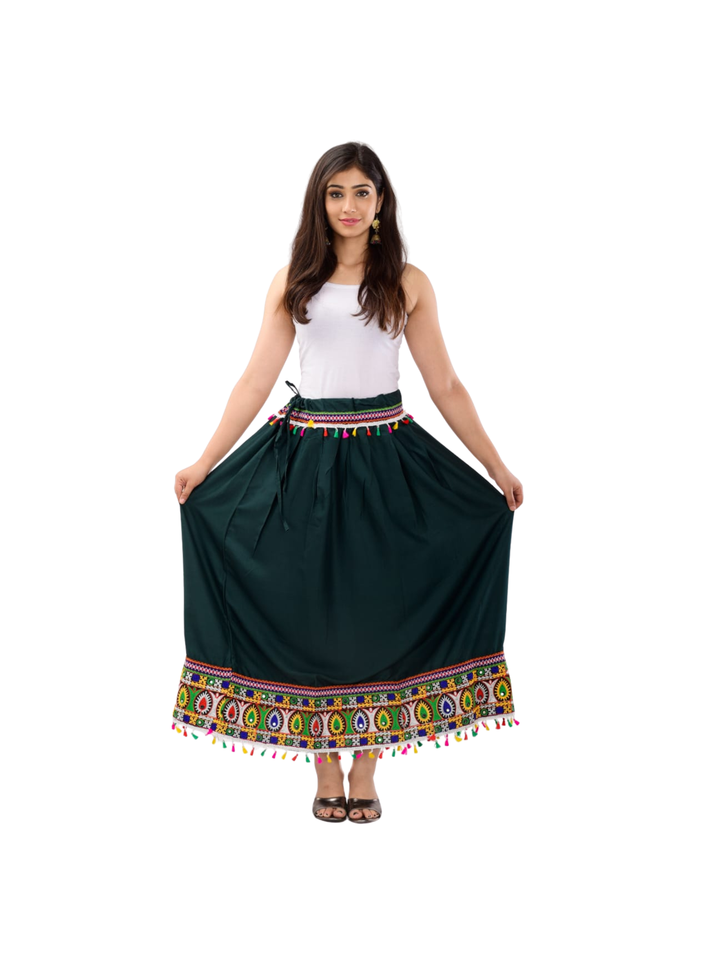Woman wearing a dark green skirt with colorful patterns and tassels on a white background