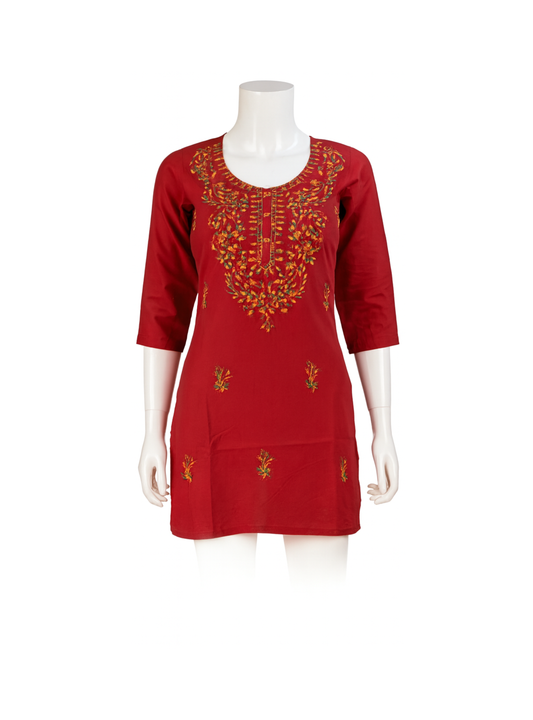 Red dress with intricate embroidery on a mannequin against a white background