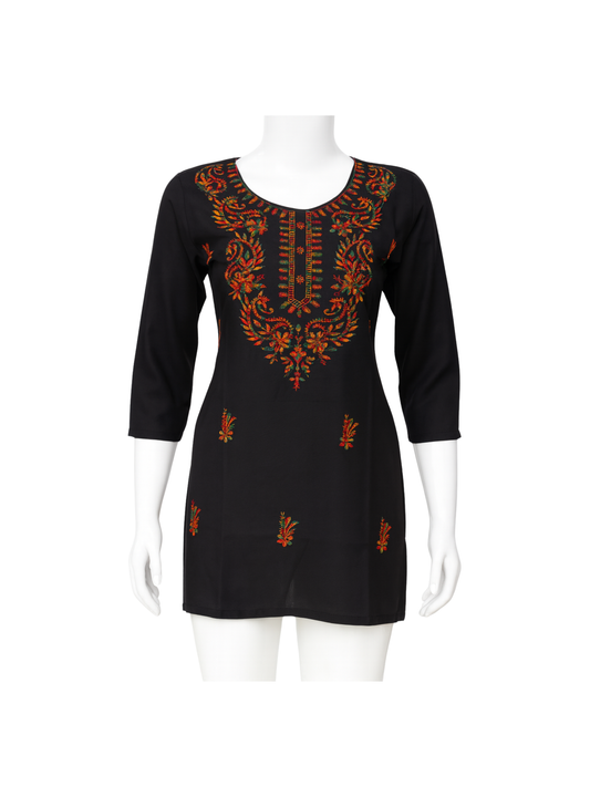 Black dress with orange embroidery on a mannequin against a white background